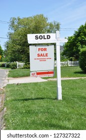 Sold Real Estate Sign On Front Yard Lawn