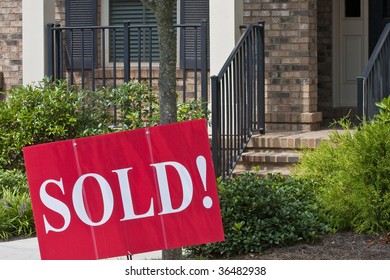 A Sold Sign In Front Of A Nice New Home