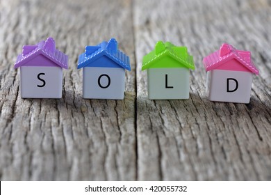 SOLD Word On Home Icon With Wooden Background