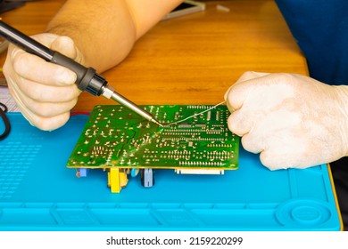 Soldering On The Board With A Soldering Iron And Repairing The Board With Solder