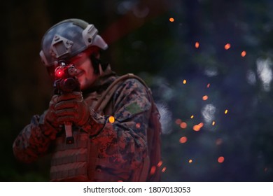 Soldier In Action At Night In The Forest Area. Night Time Military Mission