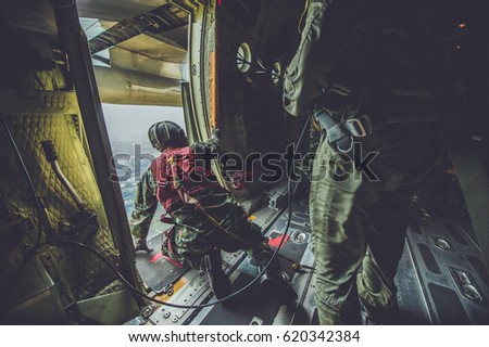Soldier (Attack Unit) parachute training From C-130 Air Force aircraft  ,  Parachute C-130  , silhouette under parachute, Military transport aircraft c-130
