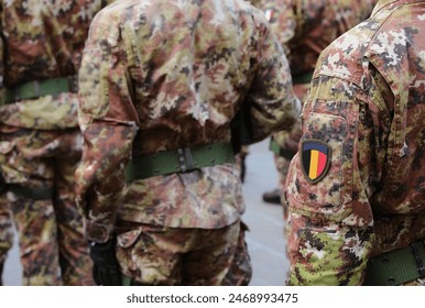 soldier of Belgian army with the green and brown camouflage uniform and the coat of arms with the Belgian flag - Powered by Shutterstock