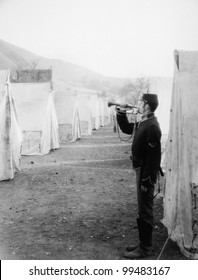 Soldier Blowing Bugle In Army Camp