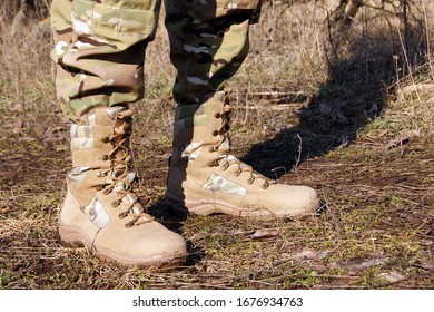 Soldier In Camouflage Pants And Army Boots.