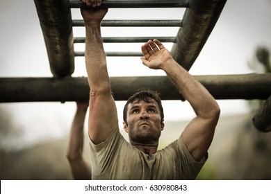 Soldier climbing monkey bars in boot camp - Powered by Shutterstock