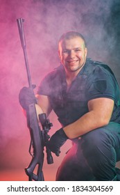 Soldier Comes Out Of The Smoke On The Battlefield. The Concept Of Military Special Operations. Kneeling And Smiling