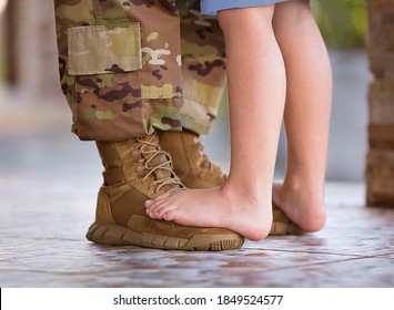 soldier dancing with child on his feet - Powered by Shutterstock