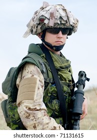 Soldier In Desert Uniform Holding His Rifle