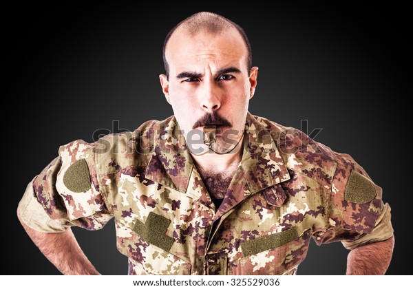 a soldier or drill sergeant blowing a whistle\
over a dark backdrop