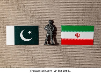 A soldier figurine on the background of the flags of Iran and Pakistan - Powered by Shutterstock