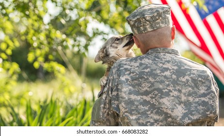 Soldier with his dog outdoors on a sunny day with american flag on the background