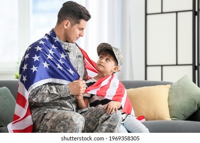 Soldier And His Little Son With USA Flag At Home. Memorial Day Celebration