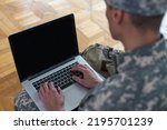 Soldier holding laptop. Military education concept