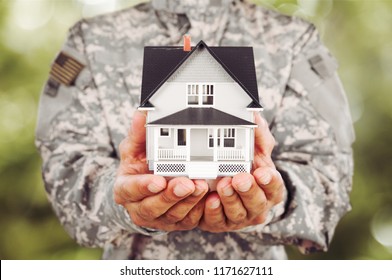 Soldier Holding a Model of House - Powered by Shutterstock