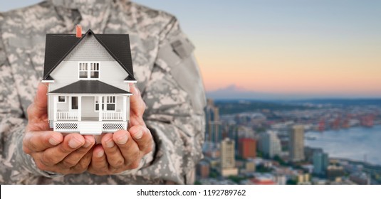 Soldier Holding a Model of House - Powered by Shutterstock