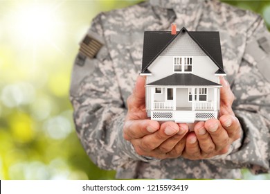 Soldier Holding a Model of House - Powered by Shutterstock