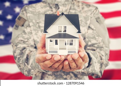 Soldier Holding a Model of House - Powered by Shutterstock