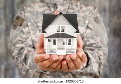 Soldier Holding a Model of House - Powered by Shutterstock