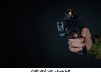 Soldier Holds Gun With Red Dot Sight In The Hand