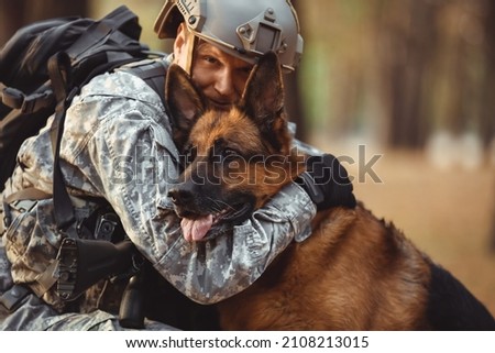 Soldier hugging military working dog outdoors