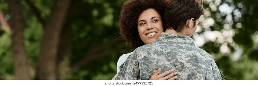 A soldier joyfully reunites with her wife in a heartfelt homecoming amidst nature. - Powered by Shutterstock