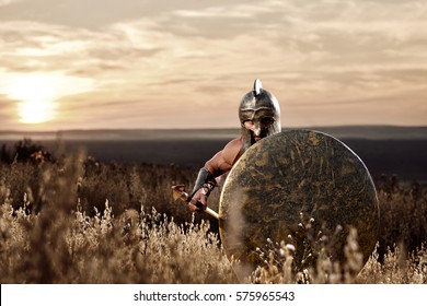 Soldier Like Spartan In Bronze Helmet Holding  Rounded Shield.