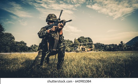 Soldier Looking Victorious With Apache Helicopter Fly Past