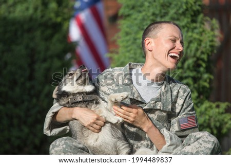 Soldier with military dog outdoors on a sunny day	