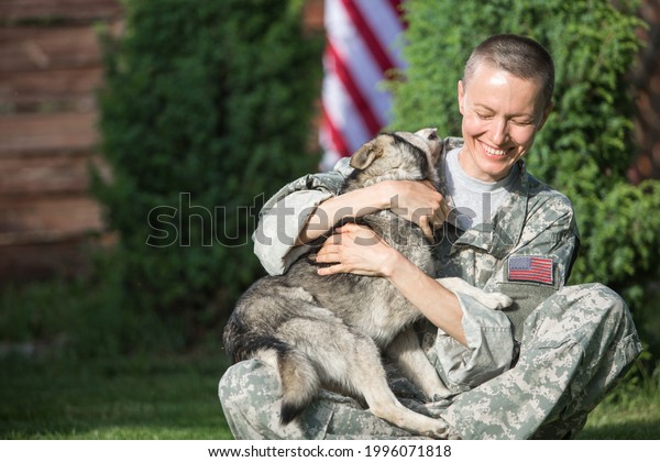 Soldier with\
military dog outdoors on a sunny\
day	