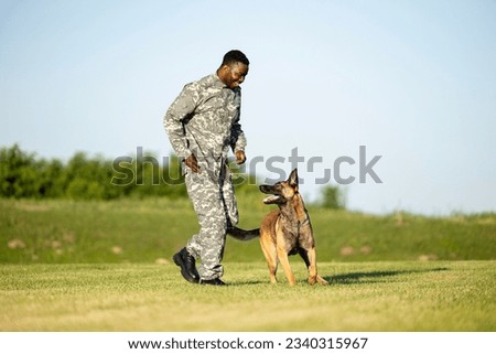 Soldier and military working dog building trust and friendship.