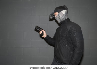 A Soldier With A Night Vision Device And A Pistol In His Hand.