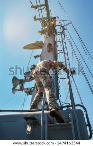 Soldier on the mast of ship.