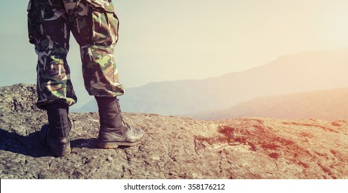 Soldier on the top of a mountain - Shutterstock ID 358176212