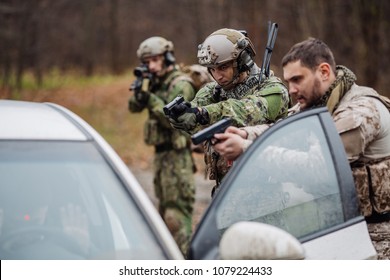 Soldier Points Gun At Suspicious Car Passenger. Anti Terrorism Military Check Point.