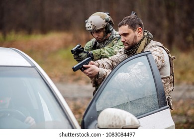 Soldier Points Gun At Suspicious Car Passenger. Anti Terrorism Military Check Point.