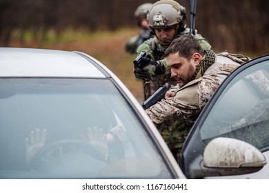 Soldier Points Gun At Suspicious Car Passenger. Anti Terrorism Military Check Point.