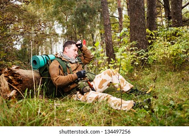 Soldier relaxing in a forest. - Powered by Shutterstock