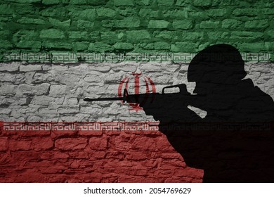 Soldier silhouette on the old brick wall with flag of iran country. Military strength