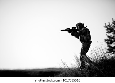 soldier of special forces in action pointing target and giving attack direction.