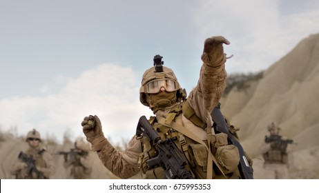 Soldier Throwing A Grenade During Combat In The Desert.