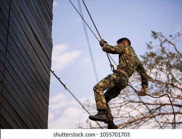 Soldier Training Rappel With Rope. Military Man Does Hanging On Climbing Equipment