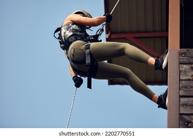 Soldier Training Rappel With Rope. Military Woman Does Hanging On Climbing Equipment