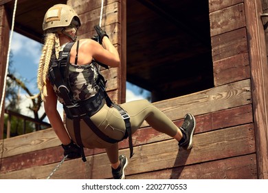 Soldier Training Rappel With Rope. Military Woman Does Hanging On Climbing Equipment