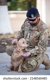 A Soldier Of The Ukrainian Army And His Dog. Ukraine, Lviv, October 13, 2018. Military Man Portrait