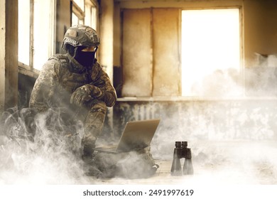 Soldier using laptop inside building during military operation - Powered by Shutterstock