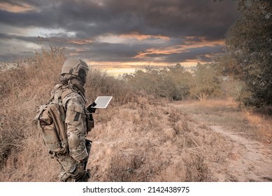 Soldier using map on tablet for orientation at forest - Powered by Shutterstock