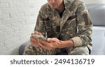 Soldier using a mobile phone against white background