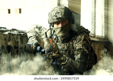 Soldier using radio in building during military operation - Powered by Shutterstock