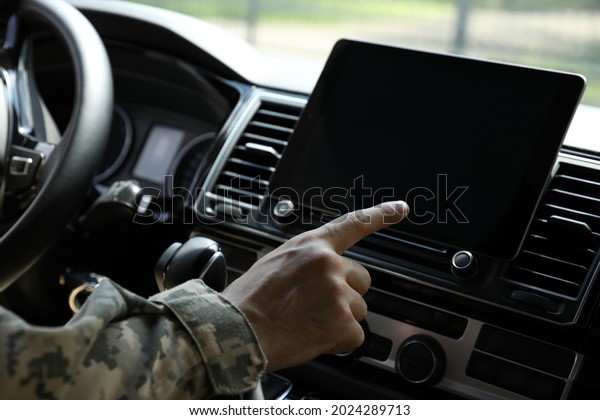 Soldier using tablet in\
car, closeup view